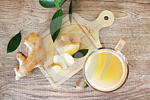 Ginger root with leaf and a glass of juice