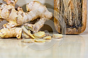 Ginger root Zingiber officinale on light and woody background