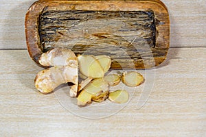 Ginger root Zingiber officinale on light and woody background