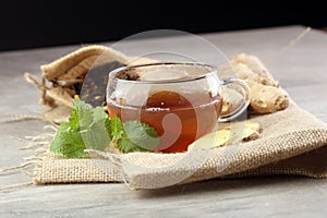 Ginger tea with mint and lemon on grey backgroundy