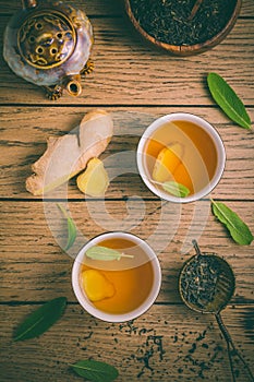 Ginger tea with sage leaves and dried black tea leaves