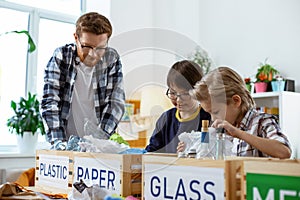 Ginger teacher in clear glasses explaining recycling bases