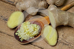 Ginger on a wooden background. Chopped ginger root. Healthy food