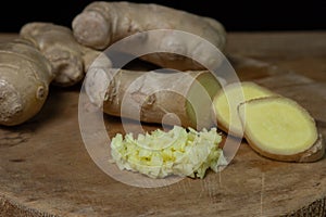 Ginger on a wooden background. Chopped ginger root. Healthy food