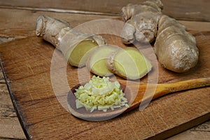 Ginger on a wooden background. Chopped ginger root. Healthy food