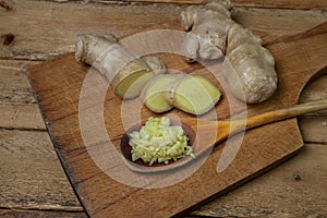 Ginger on a wooden background. Chopped ginger root. Healthy food