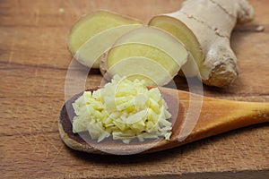 Ginger on a wooden background. Chopped ginger root. Healthy food