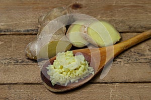 Ginger on a wooden background. Chopped ginger root. Healthy food