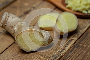 Ginger on a wooden background. Chopped ginger root. Healthy food