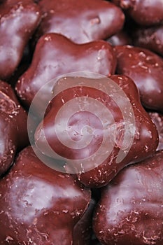 Gingerbread. Chocolate coated gingerbreads as background. Flower shaped gingerbread texture pattern. Cake texture. Cake