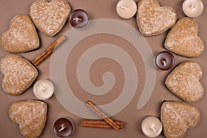 Gingerbread with cinnamon. Heart. Candles. View from above. Brown background