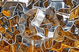 Gingerbread cookie cutter. stainless steel molds for baking christmas cookies in brown ceramic bowl.  on white with copy
