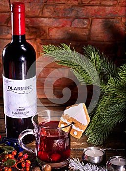 Gingerbread cookie form of house decorated mulled wine mug drink.