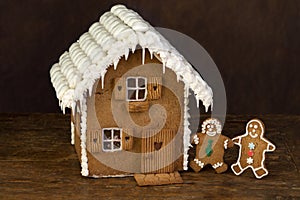 Gingerbread cookie house on wooden shelf