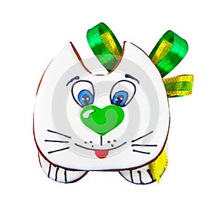 Gingerbread cookie kitten decorated with icing and green bow