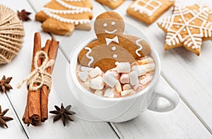 Gingerbread cookie man in cup of hot chocolate