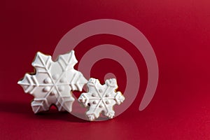 Gingerbread cookie of snowflake on red background. Traditional Christmas food. Christmas and New Year holiday concept