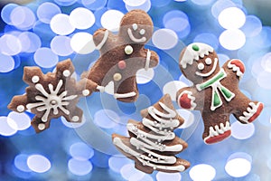 Gingerbread cookies on the background of Christmas lights.