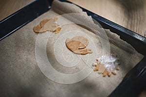 Gingerbread cookies on a baking sheet before baking