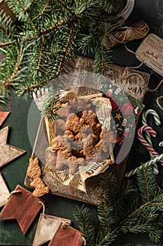 Gingerbread cookies christmas flat lay composition on green wooden table wit fir tree decorations. Top view, xmas card