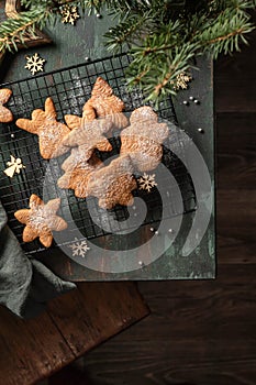 Gingerbread cookies christmas flat lay composition on green wooden table wit fir tree decorations. Top view, xmas card