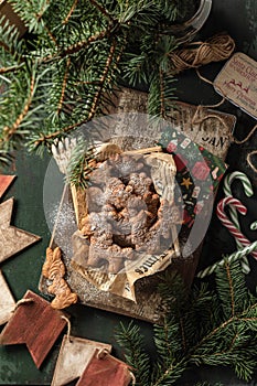 Gingerbread cookies christmas flat lay composition on green wooden table wit fir tree decorations. Top view, xmas card