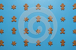 Gingerbread cookies flat lay on a blue background. Cookies arranged symmetrically on the table