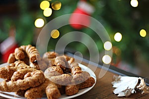 Gingerbread cookies. Plate with tasty homemade Christmas cookies on wooden table.