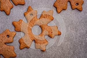 Gingerbread cookies in the shape of stars and leaves ready to hang on a Christmas tree as part of preparations for Christmas