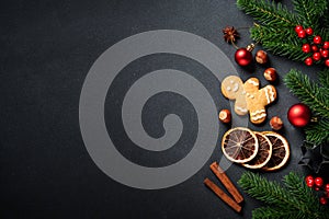 Gingerbread cookies, spices and Christmas decorations at black.