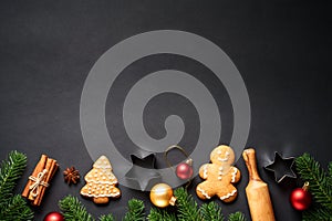 Gingerbread cookies, spices and Christmas decorations at black.