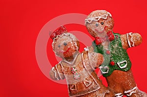 Gingerbread Couple over Red Background. Christmas Cookies