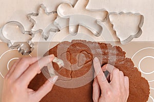 Gingerbread dough with metal cutters of different shapes.