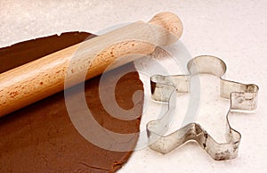 Gingerbread dough, rolling pin and cookie cutter