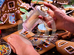 Gingerbread hause making by child hands.