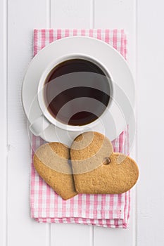 Gingerbread heart shape and coffee mug.