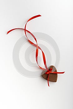 Gingerbread hearts festive on Valentines Day with red ribbon on white background. Vertical frame