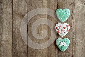 Gingerbread hearts right on wooden background and text spae