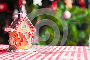 Gingerbread house decorated by sweet candies on a