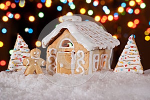 Gingerbread house with gingerbread man and christmas trees