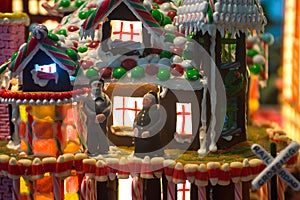 Gingerbread house with an old couple man and woman stand in the