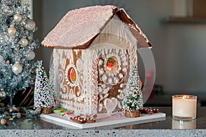 Gingerbread house with white and pink icing. Landscape horizontal side view.