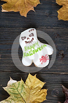 Gingerbread like cast with words Happy Halloween. Wooden background. Vertical frame