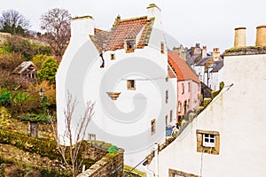 Gingerbread like white house with chimneys on orange tile roof in Culross town in Scotland