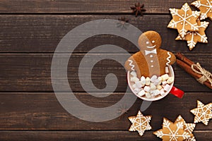 Gingerbread man bathing in cup of hot chocolate