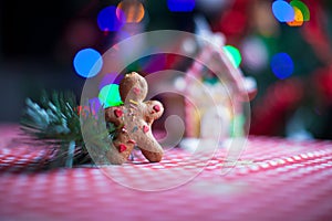 Gingerbread man in front of his candy ginger house