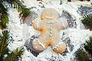 Gingerbread man making snow angel on flour