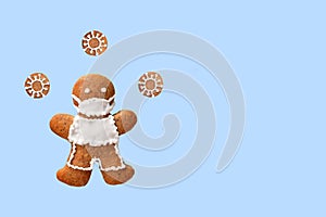 Gingerbread man with protective face mask and coronaviruses