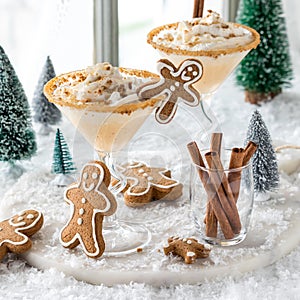 Gingerbread martinis topped with whip cream and sprinkled cookie crumbs.