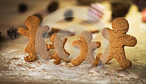 Gingerbread men made on the wooden table plate